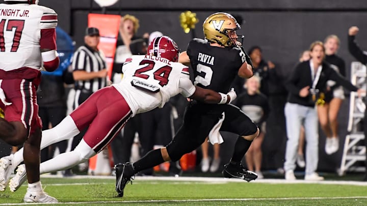 Nov 9, 2024; Nashville, Tennessee, USA;  Vanderbilt Commodores quarterback Diego Pavia (2) scores past South Carolina Gamecocks defensive back Jalon Kilgore (24) during the second half at FirstBank Stadium. Mandatory Credit: Steve Roberts-Imagn Images