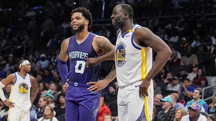 Mar 3, 2025; Charlotte, North Carolina, USA; Golden State Warriors forward Draymond Green (23) chats with Charlotte Hornets forward Miles Bridges (0) at the free throw line during the second half at Spectrum Center. Mandatory Credit: Jim Dedmon-Imagn Images
