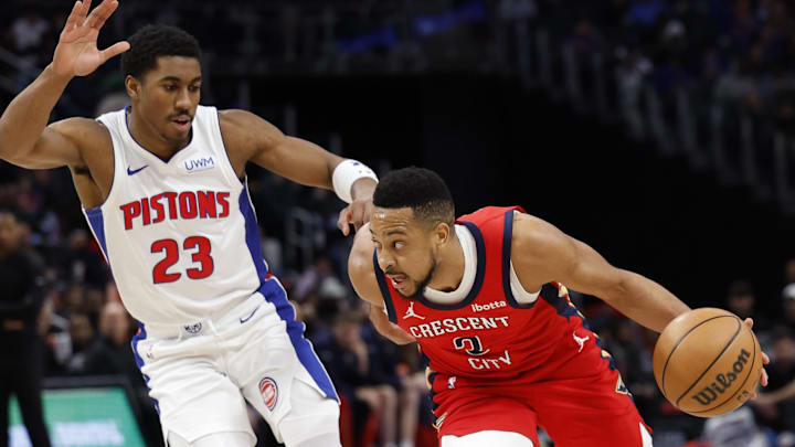 Mar 24, 2024; Detroit, Michigan, USA;  New Orleans Pelicans guard CJ McCollum (3) dribbles on Detroit Pistons guard Jaden Ivey (23): Rick Osentoski-Imagn Images