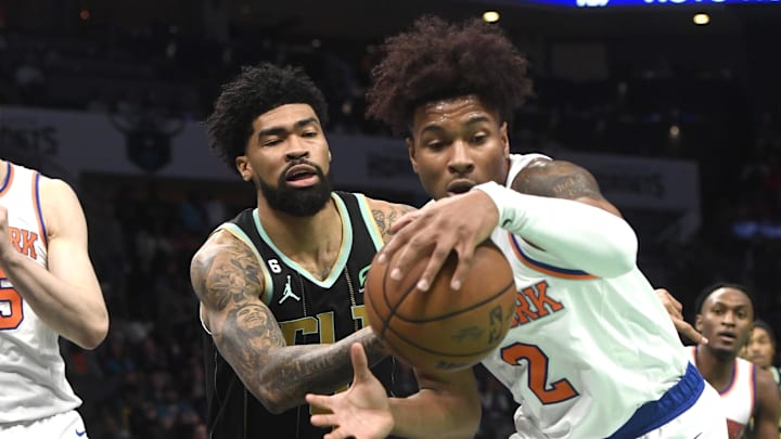 Dec 9, 2022; Charlotte, North Carolina, USA; New York Knicks guard Miles McBride (2) and Charlotte Hornets center Nick Richards (4) go after a loose ball during the second half at the Spectrum Center. Mandatory Credit: Sam Sharpe-Imagn Images