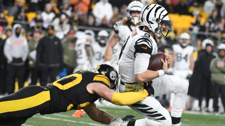 Nov 20, 2022; Pittsburgh, Pennsylvania, USA;  Cincinnati Bengals quarterback Joe Burrow is tackled by Pittsburgh Steelers linebacker T.J. Watt (90) during the second quarter at Acrisure Stadium. 