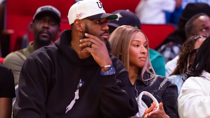 Los Angeles Lakers forward Lebron James (left) and wife Savannah James courtside during the McDonald's All American Boy's high school basketball game at Toyota Center.