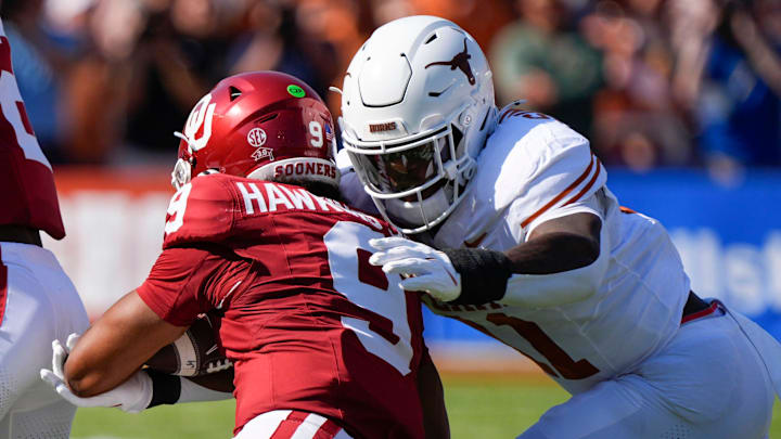 Texas Longhorns linebacker Colin Simmons (11) brings down Oklahoma Sooners quarterback Michael Hawkins Jr. (9) during the Red River Rivalry college football game between the University of Oklahoma Sooners (OU) and the Texas Longhorns at the Cotton Bowl in Dallas, Saturday, Oct. 12, 2024. Texas one 34-3. Texas Longhorns linebacker Colin Simmons (11) brings down Oklahoma Sooners quarterback Michael Hawkins Jr. (9) during the Red River Rivalry college football game between the University of Oklahoma Sooners (OU) and the Texas Longhorns at the Cotton Bowl in Dallas, Saturday, Oct. 12, 2024. Texas one 34-3.
