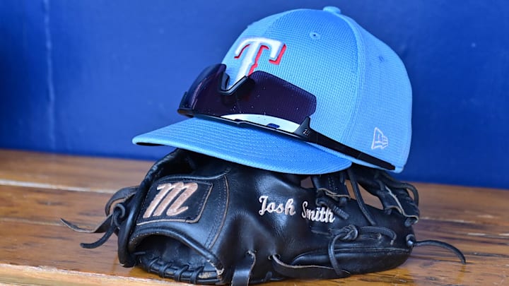 General view of a Texas Rangers hat, glove, and glasses prior to a spring training game against the Colorado Rockies at Salt River Fields at Talking Stick