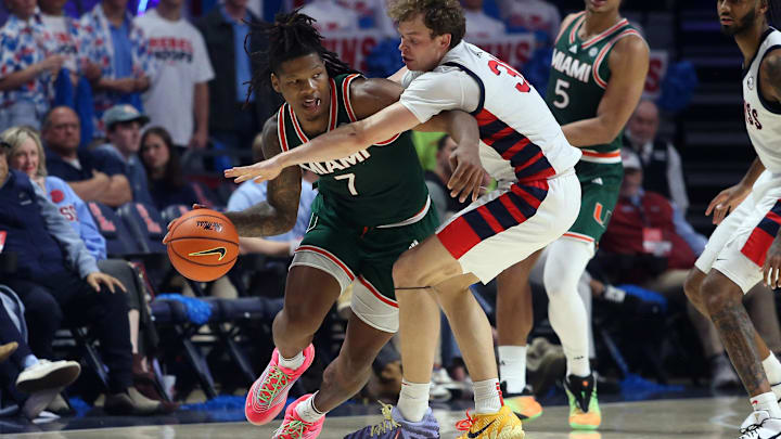 Dec 2, 2025; Oxford, Mississippi, USA; Miami Hurricanes forward Shelton Henderson (7) dribbles as Mississippi Rebels guard Zach Day (31) defends during the second half at The Sandy and John Black Pavilion at Ole Miss. Mandatory Credit: Petre Thomas-Imagn Images