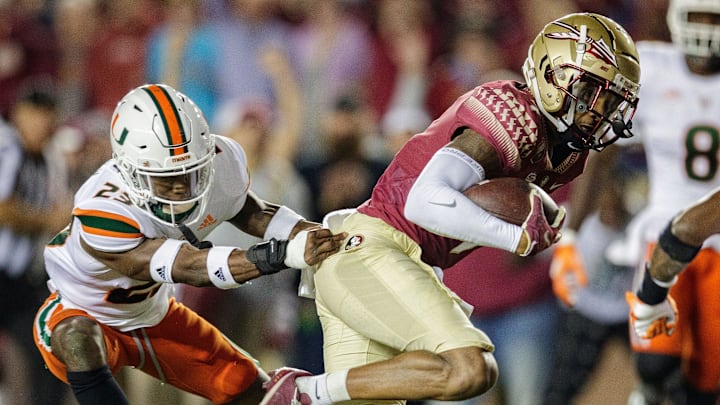 Florida State Seminoles wide receiver Andrew Parchment (7) runs towards the end zone as a defender pulls him back. The Florida State Seminoles defeated the Miami Hurricanes 31-28 Saturday, Nov. 13, 2021.

Fsu V Miami Second Half449