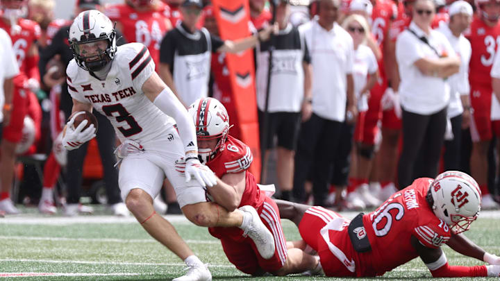 Sep 20, 2025; Salt Lake City, Utah, USA; Texas Tech Red Raiders wide receiver Coy Eakin (3) runs after a catch against Utah Utes cornerback Elijah Davis (9) and cornerback Blake Cotton (16) during the fourth quarter at Rice-Eccles Stadium. Mandatory Credit: Rob Gray-Imagn Images