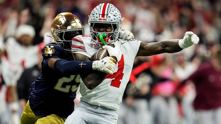 Ohio State Buckeyes wide receiver Jeremiah Smith (4) makes a catch against Notre Dame Fighting Irish cornerback Christian Gray (29) in the fourth quarter during the College Football Playoff National Championship at Mercedes-Benz Stadium in Atlanta on January 20, 2025.