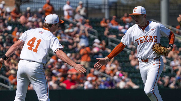 Texas Longhorns infielder Jalin Flores (1) and pitcher Cody Howard (41) celebrate a third out as they leave the field during the game against Cal Poly at UFCU Disch   Falk Field on Sunday, Feb. 24, 2024 in Austin.