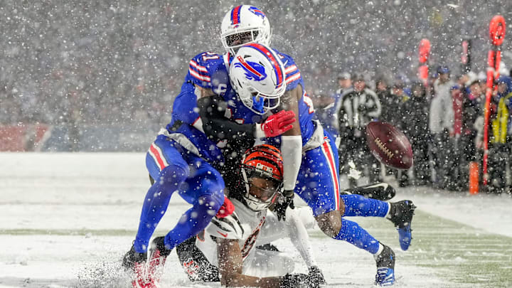 Buffalo Bills safety Jordan Poyer (21) and cornerback Tre'Davious White (27) collide over Cincinnati Bengals wide receiver Tee Higgins (85) as they cover a deep pass in the fourth quarter of the NFL divisional playoff football game between the Cincinnati Bengals and the Buffalo Bills, Sunday, Jan. 22, 2023, at Highmark Stadium in Orchard Park, N.Y. The Bengals won 27-10 to advance to the AFC Championship game against the Kansas City Chiefs.