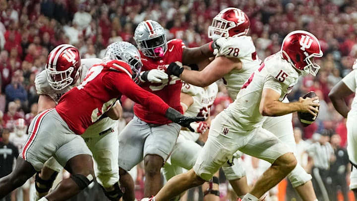 Indiana Hoosiers quarterback Fernando Mendoza (15) scrambles away from Ohio State Buckeyes defensive end Kenyatta Jackson Jr. (97) during the Big Ten Conference championship game at Lucas Oil Stadium in Indianapolis on Dec. 6, 2025. Ohio State lost 13-10. Indiana Hoosiers quarterback Fernando Mendoza (15) scrambles away from Ohio State Buckeyes defensive end Kenyatta Jackson Jr. (97) during the Big Ten Conference championship game at Lucas Oil Stadium in Indianapolis on Dec. 6, 2025. Ohio State lost 13-10.
