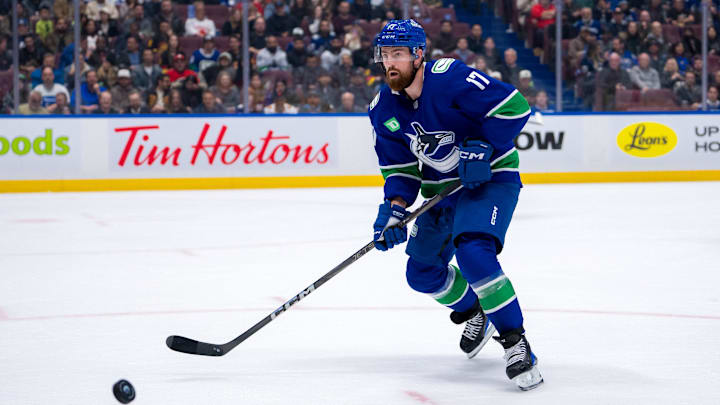 Nov 12, 2024; Vancouver, British Columbia, CAN; Vancouver Canucks defenseman Filip Hronek (17) looks for the loose puck against the Calgary Flames during the second period at Rogers Arena. Mandatory Credit: Bob Frid-Imagn Images