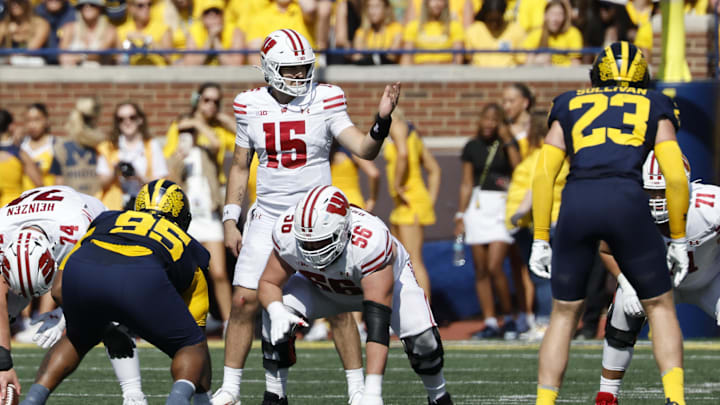 Oct 4, 2025; Ann Arbor, Michigan, USA;  Wisconsin Badgers quarterback Hunter Simmons (15) gets set to run a play in the first half against the Michigan Wolverines at Michigan Stadium. Mandatory Credit: Rick Osentoski-Imagn Images