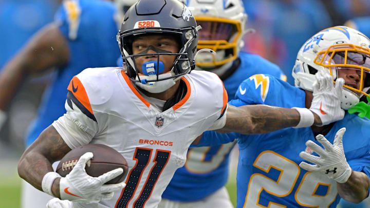Sep 21, 2025; Inglewood, California, USA; Denver Broncos wide receiver Troy Franklin (11) pushes off Los Angeles Chargers cornerback Tarheeb Still (29) as he runs the ball in the second half at SoFi Stadium. Mandatory Credit: Jayne Kamin-Oncea-Imagn Images