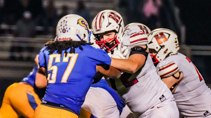 Sussex Hamilton linemen Reece Mallinger (72) holds back Germantown's Jameer Mueller (57) during the football game Sept. 19, 2025, in Germantown, Wisconsin. Hamilton won the game, 23-21.