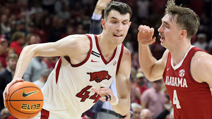 Feb 8, 2025; Fayetteville, Arkansas, USA; Arkansas Razorbacks forward Zvonimir Ivisic (44) drives against Alabama Crimson Tide forward Grant Nelson (4) during the first half at Bud Walton Arena. Mandatory Credit: Nelson Chenault-Imagn Images
