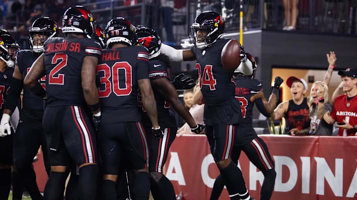Oct 21, 2024; Glendale, Arizona, USA; Arizona Cardinals safety Jalen Thompson (34) celebrates with teammates after recovering a fumble from the Los Angeles Chargers in the first half at State Farm Stadium. Mandatory Credit: Mark J. Rebilas-Imagn Images