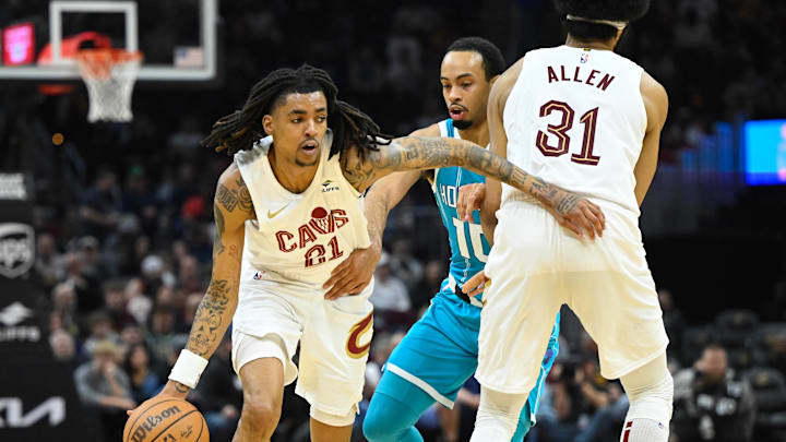 Apr 14, 2024; Cleveland, Ohio, USA; Cleveland Cavaliers forward Emoni Bates (21) dribbles around Charlotte Hornets guard Amari Bailey (10) in the second 
quarter at Rocket Mortgage FieldHouse. Mandatory Credit: David Richard-Imagn Images