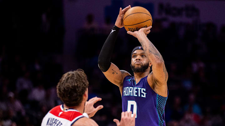 Mar 1, 2025; Charlotte, North Carolina, USA; Charlotte Hornets forward Miles Bridges (0) shoots on Washington Wizards forward Corey Kispert (24) during the second quarter at Spectrum Center. Mandatory Credit: Scott Kinser-Imagn Images Mar 1, 2025; Charlotte, North Carolina, USA; Charlotte Hornets forward Miles Bridges (0) shoots on Washington Wizards forward Corey Kispert (24) during the second quarter at Spectrum Center. Mandatory Credit: Scott Kinser-Imagn Images