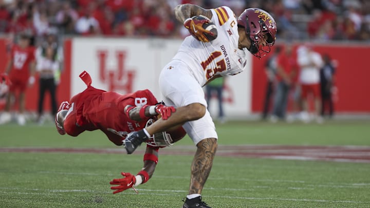 Sep 28, 2024; Houston, Texas, USA; Iowa State Cyclones wide receiver Jaylin Noel (13) runs with the ball as Houston Cougars defensive back Kentrell Webb (8) attempts to make a tackle during the first half at TDECU Stadium. Mandatory Credit: Thomas Shea-Imagn Images