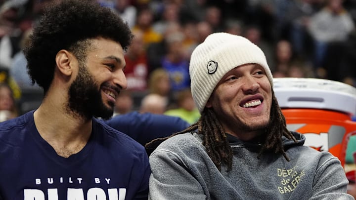 Feb 3, 2025; Denver, Colorado, USA; Denver Nuggets forward Aaron Gordon (32) and guard Jamal Murray (27) on the bench in the second half against the New Orleans Pelicans at Ball Arena. Mandatory Credit: Ron Chenoy-Imagn Images