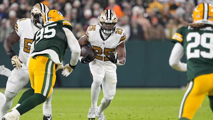 Dec 23, 2024; Green Bay, Wisconsin, USA;  New Orleans Saints running back Kendre Miller (25) rushes with the football during the second quarter against the Green Bay Packers at Lambeau Field. Mandatory Credit: Jeff Hanisch-Imagn Images