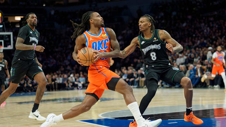 Jan 29, 2026; Minneapolis, Minnesota, USA; Oklahoma City Thunder guard Cason Wallace (22) drives on Minnesota Timberwolves guard Bones Hyland (8) in the third quarter at Target Center. Mandatory Credit: Matt Blewett-Imagn Images