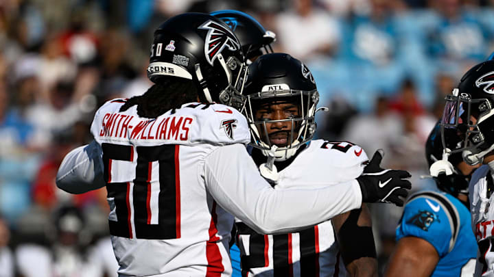 Oct 13, 2024; Charlotte, North Carolina, USA;  Atlanta Falcons defensive end James Smith-Williams (50) reacts with cornerback Dee Alford (20) in the first quarter at Bank of America Stadium.