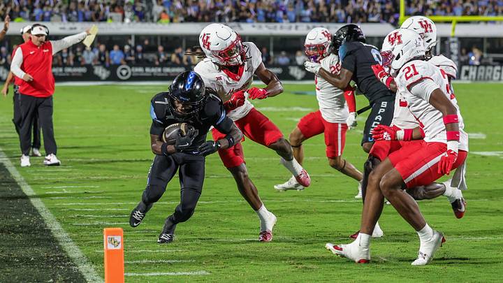 Nov 7, 2025; Orlando, Florida, USA; UCF Knights wide receiver Duane Thomas Jr. (7) is forced out of bounds by Houston Cougars defensive back Kentrell Webb (8) during the first quarter at Acrisure Bounce House. Mandatory Credit: Mike Watters-Imagn Images