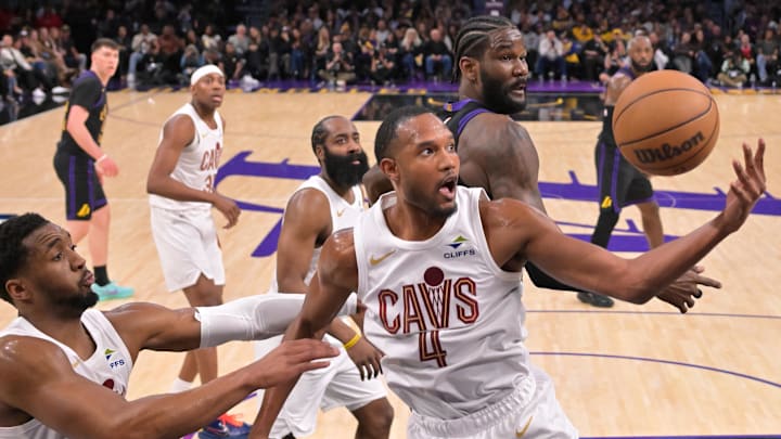 Mar 31, 2026; Los Angeles, California, USA;  Cleveland Cavaliers guard Donovan Mitchell (45) and center Evan Mobley (4) reach in front of Los Angeles Lakers center Deandre Ayton (5) for a rebound in the first half at Crypto.com Arena. Mandatory Credit: Jayne Kamin-Oncea-Imagn Images