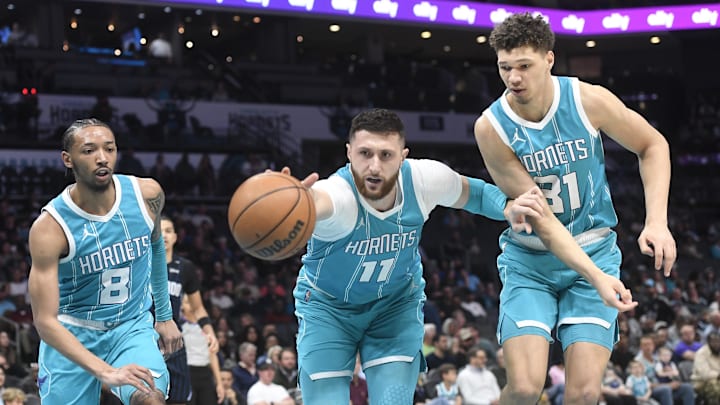 Mar 25, 2025; Charlotte, North Carolina, USA;  Charlotte Hornets center Jusuf Nurkic (11) reaches for a loose ball during the first half against the Orlando Magic at the Spectrum Center. Mandatory Credit: Sam Sharpe-Imagn Images