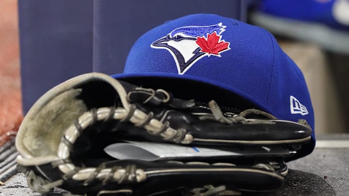 Jun 18, 2025; Toronto, Ontario, CAN; A Toronto Blue Jays cap and glove sits in the dugout during a game against the Arizona Diamondbacks at Rogers Centre. Mandatory Credit: John E. Sokolowski-Imagn Images Jun 18, 2025; Toronto, Ontario, CAN; A Toronto Blue Jays cap and glove sits in the dugout during a game against the Arizona Diamondbacks at Rogers Centre. Mandatory Credit: John E. Sokolowski-Imagn Images