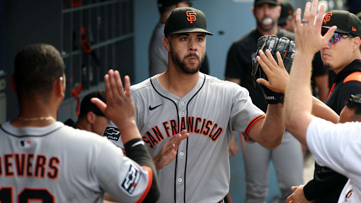 San Francisco Giants relief pitcher Joey Lucchesi (middle) is greeted in the dugout after being relieved from the game during the ninth inning against the Los Angeles Dodgers at Dodger Stadium. 