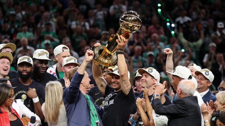Jun 17, 2024; Boston, Massachusetts, USA; Boston Celtics head coach Joe Mazzulla holds up the trophy as he celebrates after winning the 2024 NBA Finals against the Dallas Mavericks at TD Garden. Mandatory Credit: Peter Casey-USA TODAY Sports
