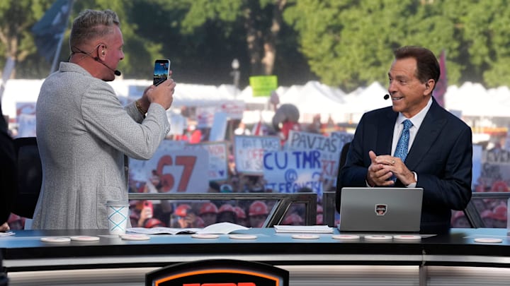 Pat McAfee takes a photo with Nick Saban on the ESPN College GameDay desk.