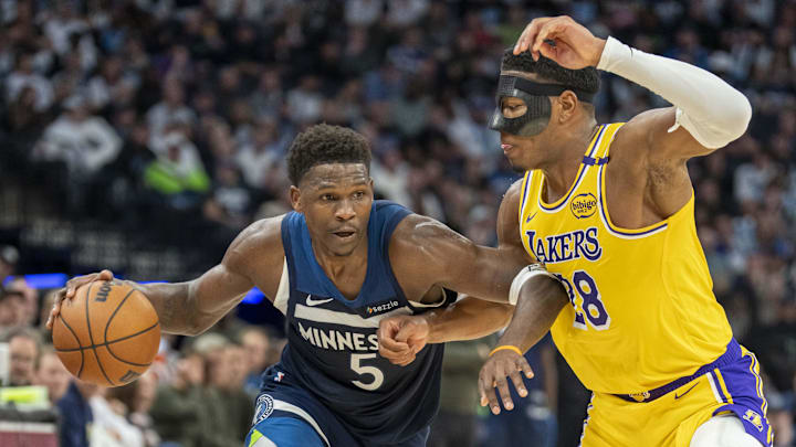 Apr 25, 2025; Minneapolis, Minnesota, USA; Minnesota Timberwolves guard Anthony Edwards (5) dribbles the ball as Los Angeles Lakers forward Rui Hachimura (28) plays defense in the second half during game three of first round for the 2024 NBA Playoffs at Target Center. Mandatory Credit: Jesse Johnson-Imagn Images