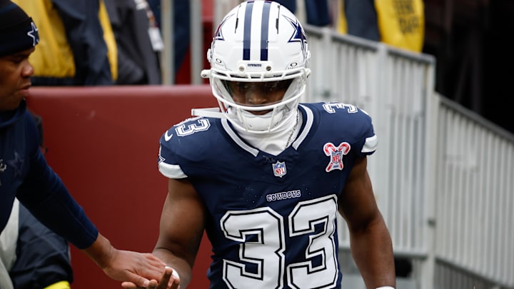 Dallas Cowboys running back Javonte Williams runs onto the field before the game against the Washington Commanders 