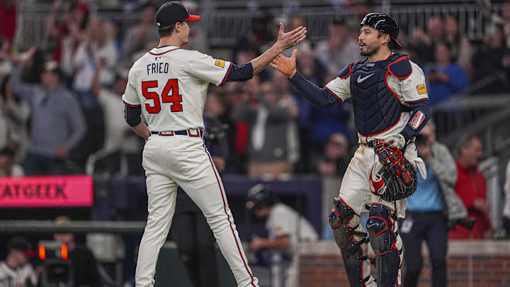 Apr 23, 2024; Cumberland, Georgia, USA; Atlanta Braves pitcher Max Fried (54) reacts with catcher Travis d'Arnaud (16) after pitching a complete game shutout against the Miami Marlins at Truist Park. Mandatory Credit: Dale Zanine-Imagn Images