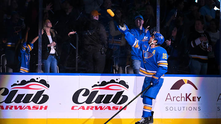 Mar 13, 2026; St. Louis, Missouri, USA; St. Louis Blues center Robert Thomas (18) tosses a t-shirt in to the crowd after he was named first star of the game after scoring a game winning goal in overtime against the Edmonton Oilers at Enterprise Center. Mandatory Credit: Jeff Curry-Imagn Images