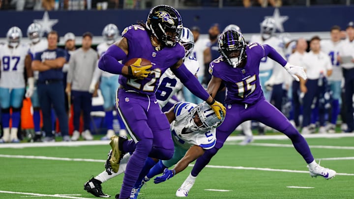 Sep 22, 2024; Arlington, Texas, USA; Baltimore Ravens running back Derrick Henry (22) stiff arms Dallas Cowboys cornerback Jourdan Lewis (2) during the third quarter at AT&T Stadium. Mandatory Credit: Andrew Dieb-Imagn Images