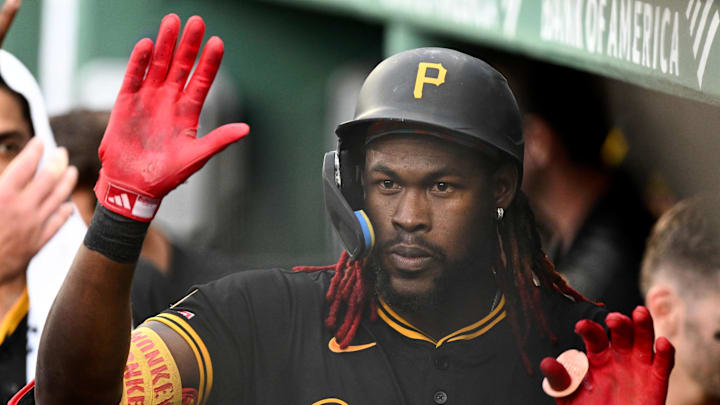 Aug 30, 2025; Boston, Massachusetts, USA; Pittsburgh Pirates center fielder Oneil Cruz (15) high-fives his teammates after hitting a solo home run against the Boston Red Sox during the fifth inning at Fenway Park. Mandatory Credit: Brian Fluharty-Imagn Images