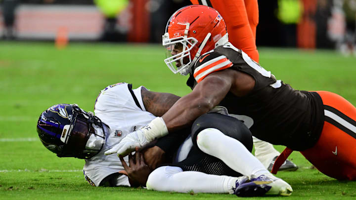 Nov 16, 2025; Cleveland, Ohio, USA; Baltimore Ravens quarterback Lamar Jackson (8) is sacked by Cleveland Browns defensive end Myles Garrett (95) during the first quarter at Huntington Bank Field. Mandatory Credit: Ken Blaze-Imagn Images