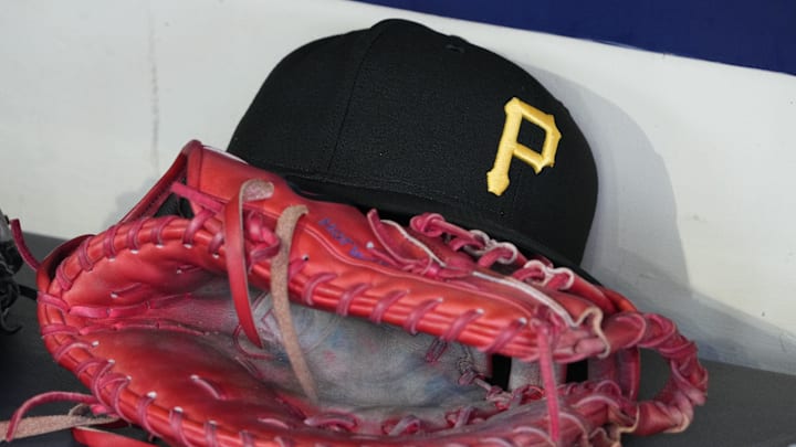 Jun 23, 2025; Milwaukee, Wisconsin, USA; against the Pittsburgh Pirates hat and glove in the dugout before a game against the Milwaukee Brewers at American Family Field. Mandatory Credit: Michael McLoone-Imagn Images