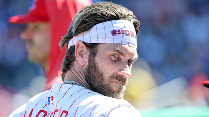 Feb 28, 2025; Clearwater, Florida, USA;  Philadelphia Phillies first base Bryce Harper (3) looks on in the dugout against the Boston Red Sox at BayCare Ballpark