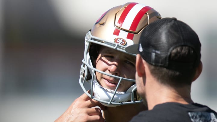 Jul 26, 2024; Santa Clara, CA, USA; San Francisco 49ers quarterback Brock Purdy (13) talks with a coach during Day 4 of training camp at SAP Performance Facility. Mandatory Credit: D. Ross Cameron-USA TODAY Sports