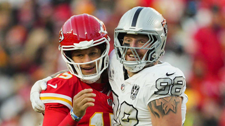 Kansas City Chiefs QB Patrick Mahomes (15) and Las Vegas Raiders defensive end Maxx Crosby (98) embrace during their game in November.