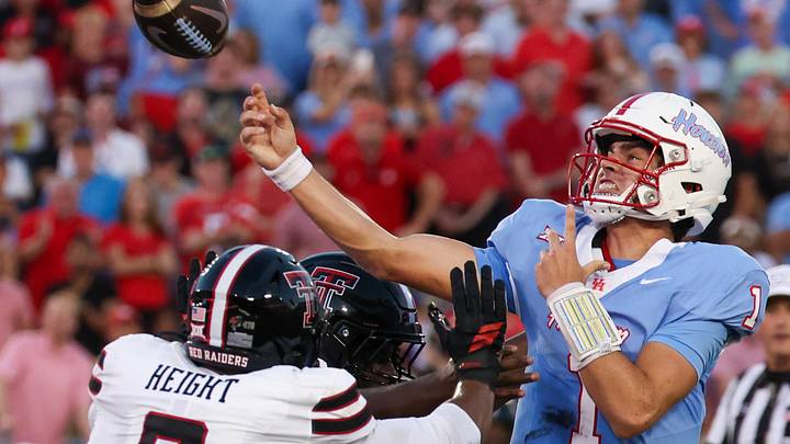 Oct 4, 2025; Houston, Texas, USA; Houston Cougars quarterback Conner Weigman (1) passes while being rushed by Texas Tech Red Raiders defensive end Romello Height (9) in the first half at TDECU Stadium. Mandatory Credit: Thomas Shea-Imagn Images Oct 4, 2025; Houston, Texas, USA; Houston Cougars quarterback Conner Weigman (1) passes while being rushed by Texas Tech Red Raiders defensive end Romello Height (9) in the first half at TDECU Stadium. Mandatory Credit: Thomas Shea-Imagn Images