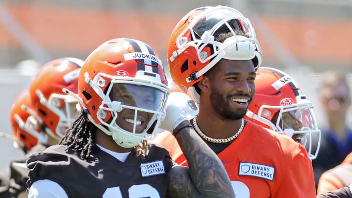 Cleveland Browns running back Quinshon Judkins (10) and quarterback Shedeur Sanders (12) share a laugh on the sideline during NFL rookie minicamp at the Cleveland Browns training facility on Friday, May 9, 2025, in Berea, Ohio.