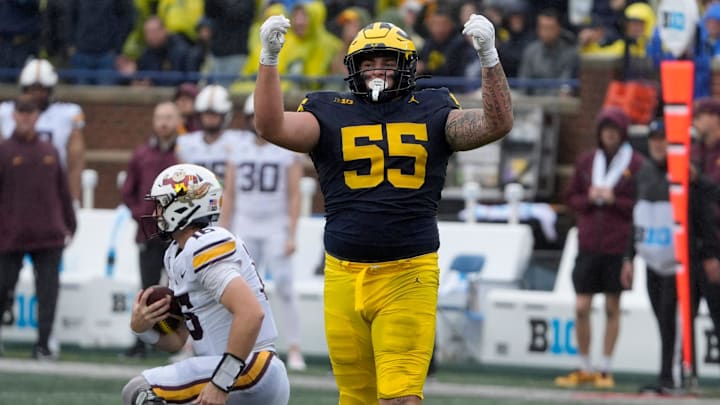 Michigan defensive lineman Mason Graham celebrates after sacking Minnesota quarterback Max Brosmer, in the background, during first-half action between Michigan and Minnesota at Michigan Stadium in Ann Arbor on Saturday, Sept. 28, 2024.