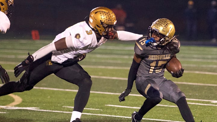 Reidsville's Dionte Neal tries to elude a Shelby defender in the 2023 North Carolina 2-A Western Region championship game.